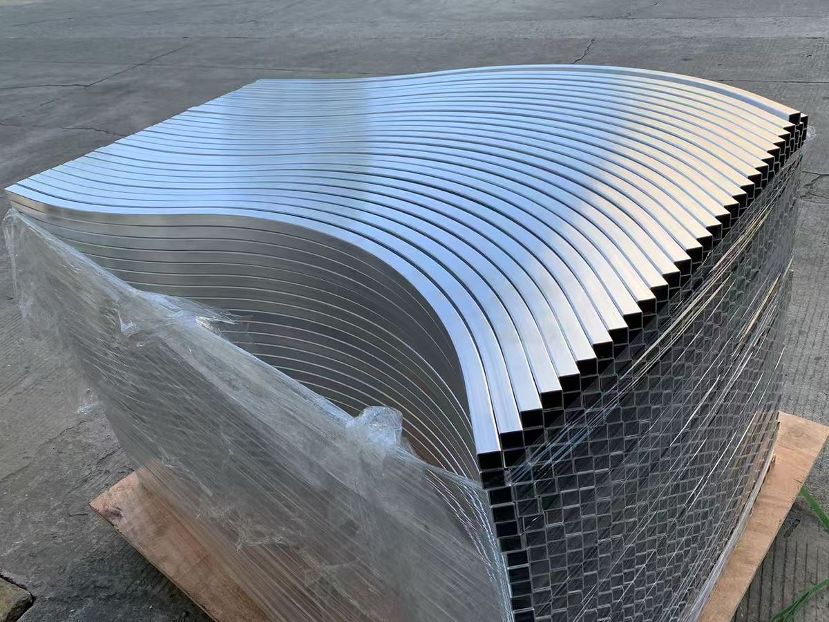 Stack of aluminium square tube bent to a large, consistent radius