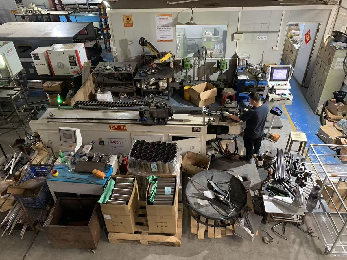 CNC tube bender W004 running, inspection bench behind