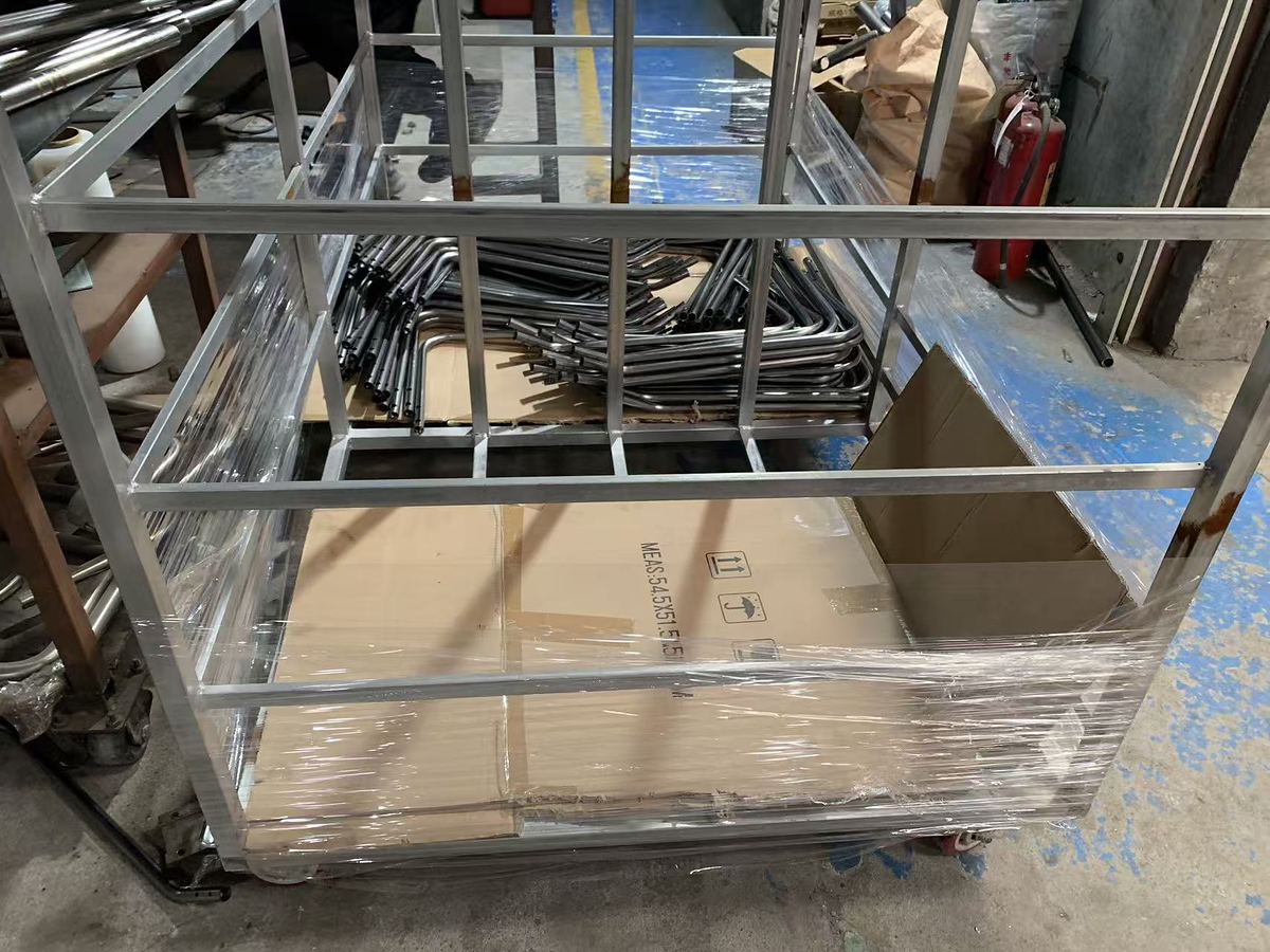 Packaging frame wrapped in stretch film beside an export carton