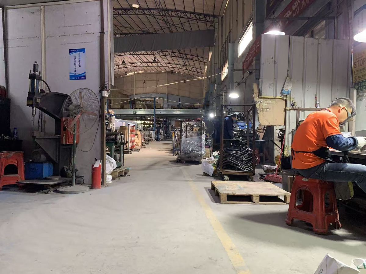 Tube bending workshop with an operator at a CNC bender